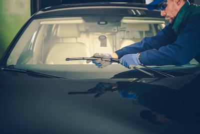 Reinstalling the windshield wipers after a windshield repair.